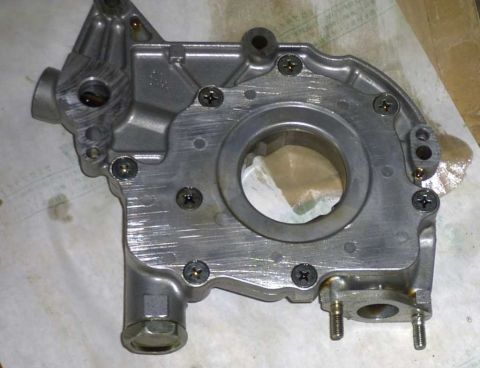 1997 Ford Taurus - A metal oil pump component is shown in detail, with visible wear and oil stains.