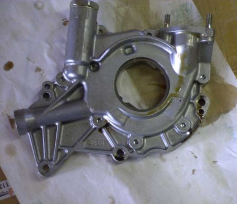 1997 Ford Taurus - A silver oil pump with "40893" cast into its housing is shown on a white surface.