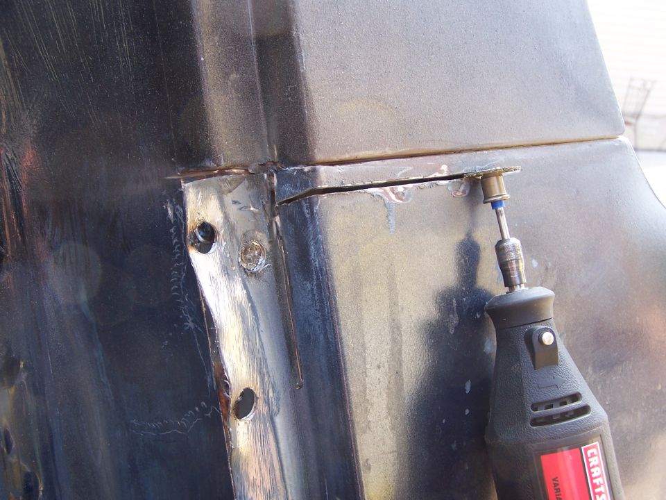 Welded sheet metal panel being worked with a power tool