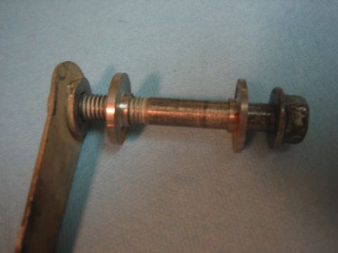 2001 Jeep Wrangler - Close-up view of a bolt with washers and a metal bracket, likely a mechanical component.