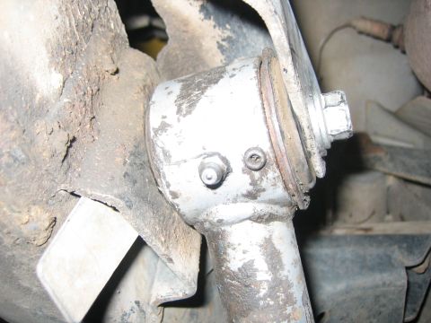 2001 Jeep Wrangler - Suspension component a grease fitting and bolt, likely part of a vehicle's undercarriage.