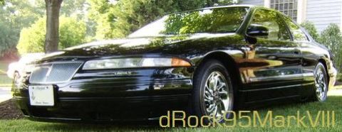 1996 Mercury Grand Marquis - A black Lincoln Mark VIII is shown from a low angle, parked on a grassy lawn in front of a house.