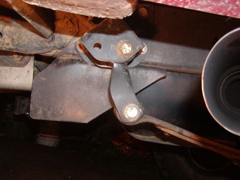 1991 Ford Bronco - This is a close-up view of a vehicle's rear suspension shackle and part of the exhaust system.