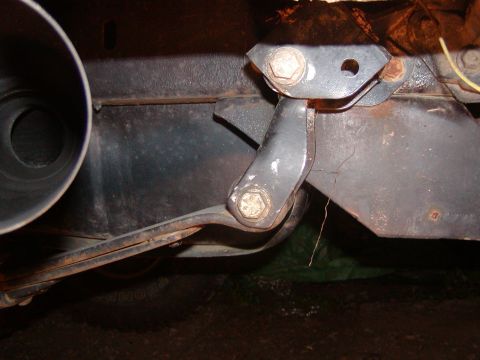 1991 Ford Bronco - A close-up view of a vehicle's suspension system, showing metal components and rust.