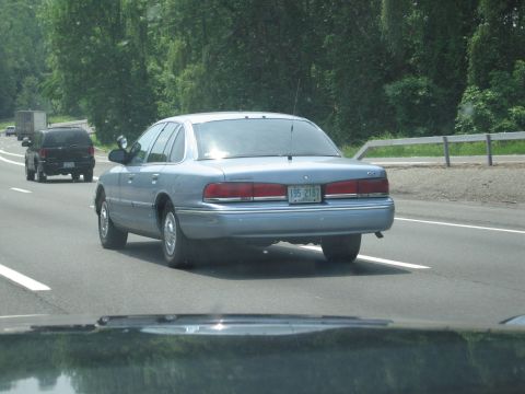 1991 Ford LTD Crown Victoria - Rear view of a 1991 Ford Crown Victoria LTD driving on a highway.