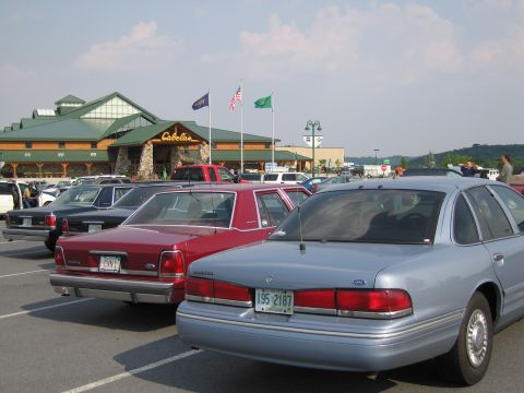 1991 Ford LTD Crown Victoria - A light blue 1991 Ford Crown Victoria LTD is parked in a lot in front of a Cabela's store.