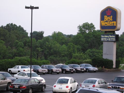 1991 Ford LTD Crown Victoria - A parking lot scene a Best Western Hotel sign and multiple vehicles under an overcast sky.