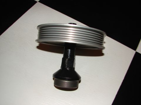 1992 Ford Taurus - A multi-groove pulley is shown against a checkered background.