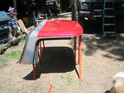 1979 Ford Bronco - A vehicle's removable roof section is shown outdoors, supported by orange sawhorses.