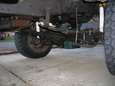 1978 Ford F-250 - Close-up view of the undercarriage of a 1978 Ford F-250, highlighting its suspension components and tires.