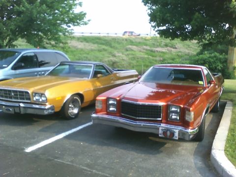 1972 Ford Ranchero - Two Ford Rancheros are parked side-by-side in a parking lot on a sunny day.