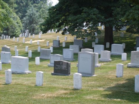 2004 Ford Crown Victoria - A vast cemetery scene with numerous tombstones dotting the grassy landscape.