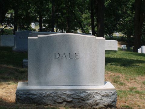 2004 Ford Crown Victoria - A headstone marked 'DALE' stands in a cemetery, surrounded by other graves and trees.