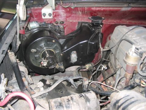 1991 Ford Bronco - The HVAC blower motor assembly is visible in the engine bay, alongside other engine parts.