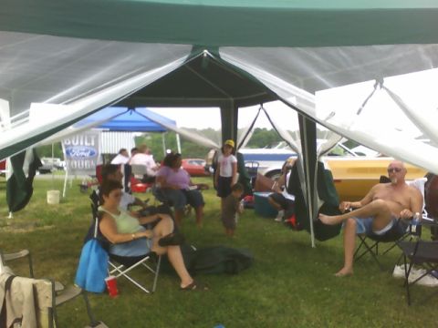1972 Ford Ranchero - Outdoor gathering under a tent with a Ford banner in the background.