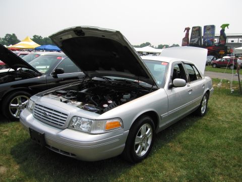1991 Ford LTD Crown Victoria - Silver Ford Crown Victoria at a car show, hood open, revealing the engine compartment.