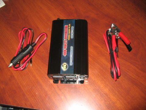 1991 Ford Bronco - A black 400 watt power inverter for video games is shown with its included cables and alligator clips.
