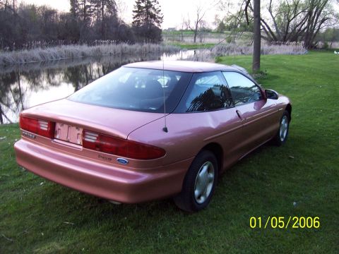 1996 Ford Probe - Rear view of a 1996 Ford Probe in a grassy, outdoor setting.