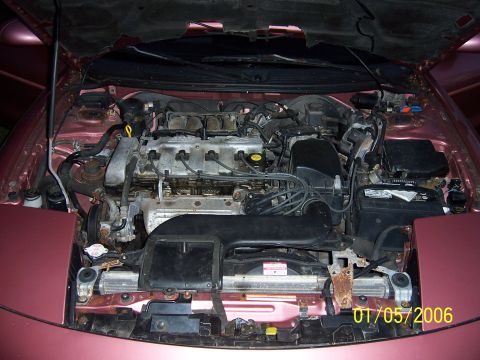 1996 Ford Probe - Engine bay of a 1996 Ford Probe, showing the V6 engine and associated components.