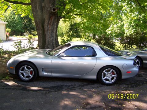 1996 Ford Probe - A silver Mazda RX-7 is parked outdoors, with another car visible behind it.