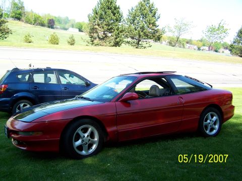1996 Ford Probe - Two vehicles parked on grass, a red Ford Probe and a blue SUV, with a date stamp of 05/19/2007.