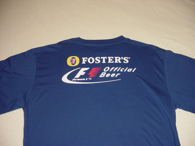 Blue t-shirt with white and red Foster's Official Beer Formula 1 logo on the back