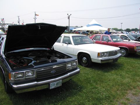 1991 Ford LTD Crown Victoria - A 1991 Ford Crown Victoria LTD is displayed with its hood open at an outdoor car show.
