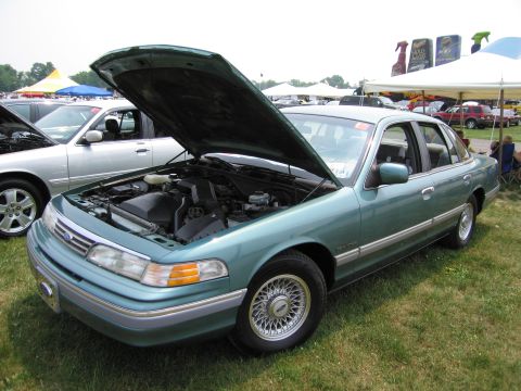 1991 Ford LTD Crown Victoria - A 1991 Ford Crown Victoria LTD is displayed with its hood open at a car show.