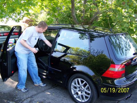 1996 Ford Probe - A man opens the door of a black Volkswagen Golf GTI, with a date stamp of 05/19/2007 visible on the rear quarter panel.