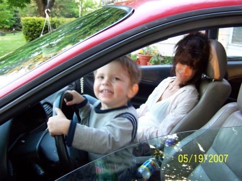 1996 Ford Probe - A young child plays at the steering wheel of a car with a woman in the passenger seat, as seen on May 19, 2007.