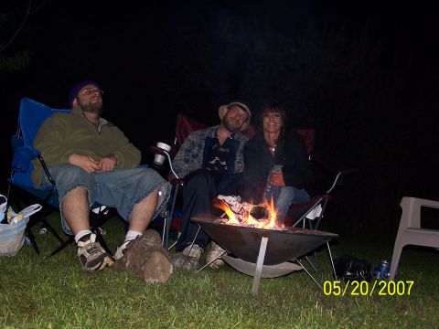 1996 Ford Probe - People enjoy a campfire gathering outdoors at night.