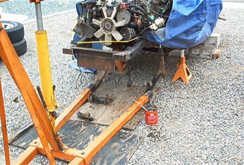 1982 Toyota 4Runner - An engine is suspended by a hoist, undergoing maintenance or repair work.