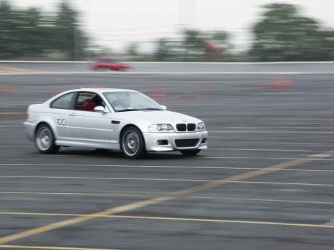 2001 Mercury Grand Marquis - Silver BMW M3 coupe on track, with another red car blurred in the background.