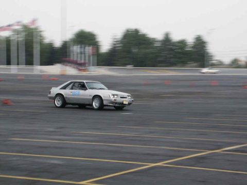 2001 Mercury Grand Marquis - A silver coupe navigates an autocross course with another vehicle in the background.
