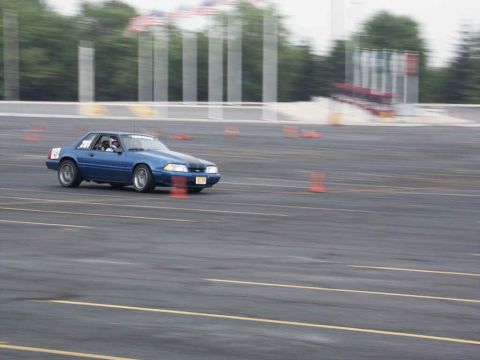 2001 Mercury Grand Marquis - Ford Mustang with racing numbers navigates a course marked by traffic cones.