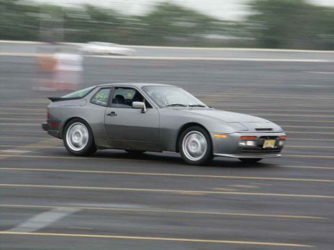 2001 Mercury Grand Marquis - A gray coupe is captured in motion on a track, with the number 45 visible on its side.