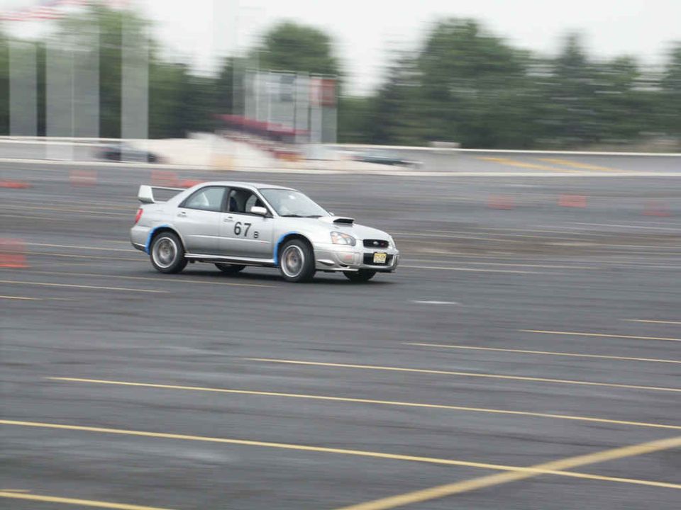 Silver Subaru Impreza WRX STI with racing number 67 on track