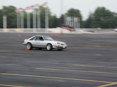 2001 Mercury Grand Marquis - Silver coupe with number 858 on door driving on a track during an event.