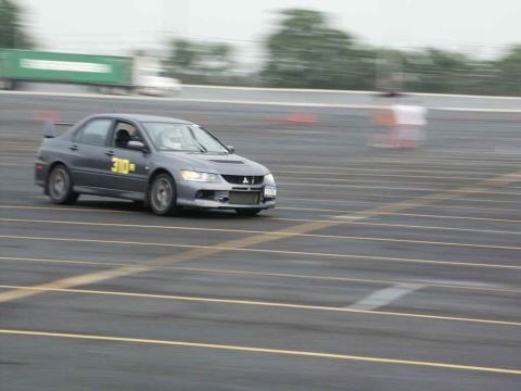 2001 Mercury Grand Marquis - A gray Mitsubishi Lancer Evolution VIII, identified by the number 310, is captured in motion on a race track.