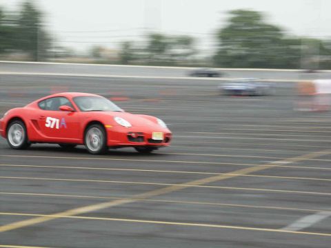 2001 Mercury Grand Marquis - Sports car racing on a track, with other vehicles blurred in the background.
