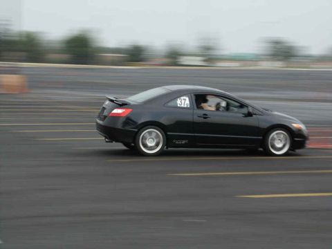2001 Mercury Grand Marquis - Black coupe with racing number 37 on the door, captured in motion on a track.
