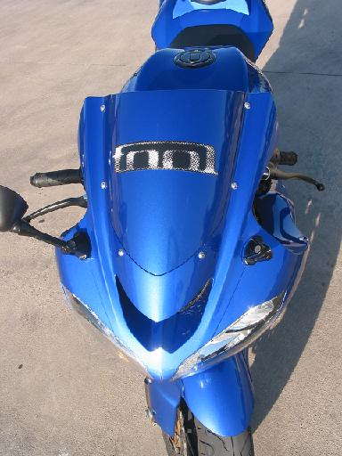 1996 Ford Bronco - A blue sport motorcycle is parked on a concrete surface, viewed from the front.