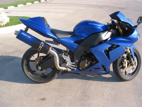 1996 Ford Bronco - A blue Kawasaki motorcycle is parked on a concrete surface with a Micron exhaust visible.