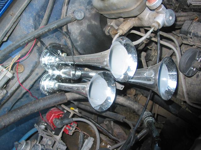 chrome train horns mounted in engine bay