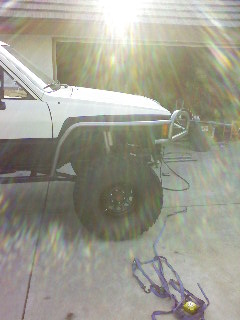 1985 Toyota 4Runner - A white 1985 Toyota 4Runner is shown from the front quarter angle, modified with aftermarket body protection.