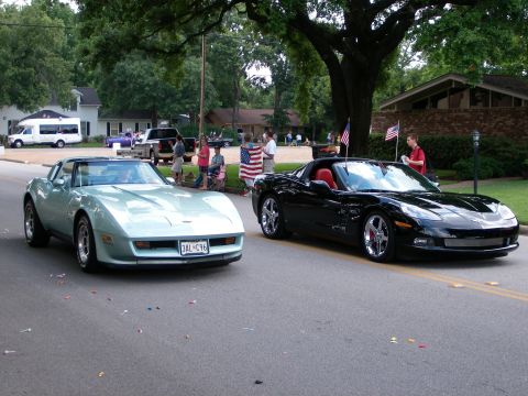 2000 Ford Crown Victoria - Two Chevrolet Corvettes, a C3 and a C6, are seen participating in a parade.