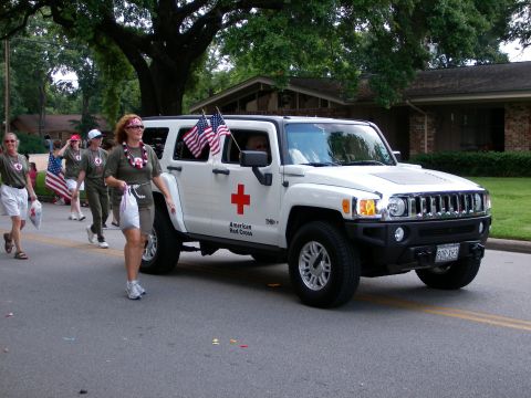 2000 Ford Crown Victoria - American Red Cross Hummer H3 participating in a parade.