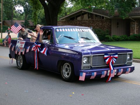 2000 Ford Crown Victoria - Purple pickup truck decorated with patriotic elements for a parade.