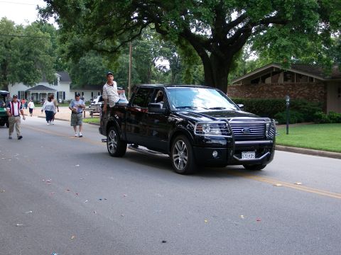 2000 Ford Crown Victoria - Black Ford F-150 pickup truck with a bull bar and aftermarket wheels.