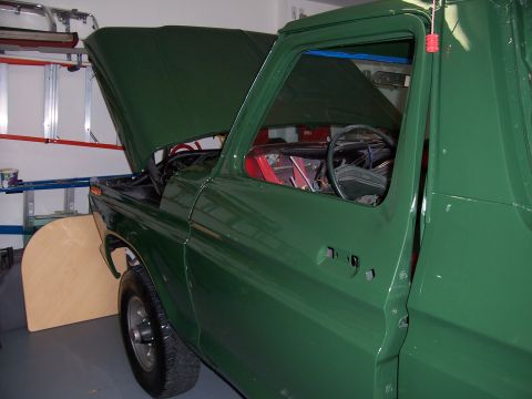 1978 Ford Bronco - This 1978 Ford Bronco is shown with its hood open, revealing the engine bay and interior components.